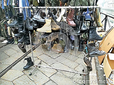 Men`s shoes at a vintage market: amphibians, boots, ankle boots, sneakers Editorial Stock Photo