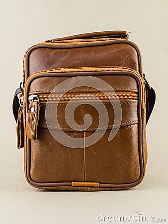 Men`s small brown leather bag is on the table Stock Photo