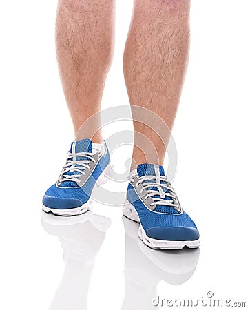 Men`s sports legs in sneakers. Stock Photo