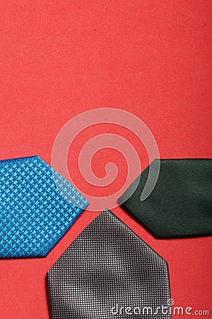 Men`s ties in different colors and sizes. For father and sons. Love and Togetherness Objects. On a coral background Stock Photo