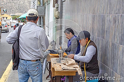Men sew on sewing machines on the street. Quito, Ecuador. 01/13/2019 Editorial Stock Photo
