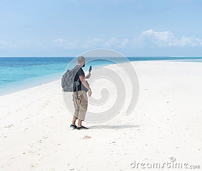 Men with smartphone camera filming beautiful tropical beach Stock Photo
