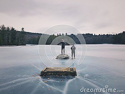 Men standing on frozen lake Editorial Stock Photo