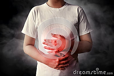 Men stomach ache on smoke background Stock Photo