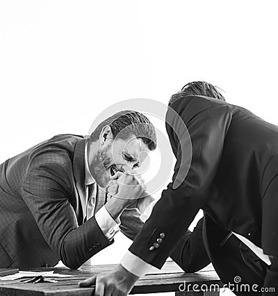 Men in suit or businessmen with screaming face compete in armwrestling on table on white background. Winner and defeated Stock Photo