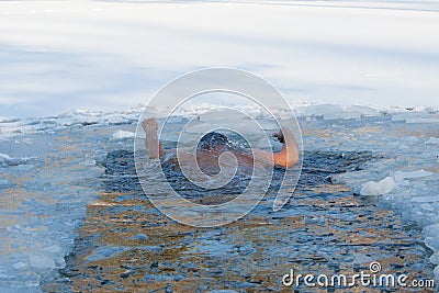 Men swims invisible under water hands are up in ice hole, Drown Stock Photo