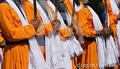 Men with the swords and cerimonial clothes druing a sikh parade Stock Photo