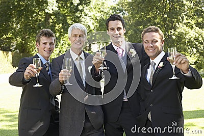 Men Toasting Champagne Flutes At Wedding Stock Photo