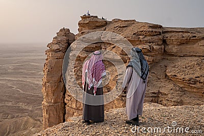 Two Arab men in traditional clothing at the Edge of the World near Riyadh in Saudi Arabia Stock Photo