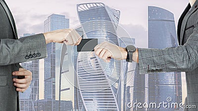 Men transferring a credit card or business card against the background of buildings of skyscrapers Stock Photo