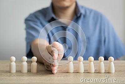 Men use barriers or blocks between wood figure Two groups that are fighting are ending the problem, finding a common solution, Stock Photo