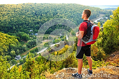 Men walk along the hill with backpack Stock Photo