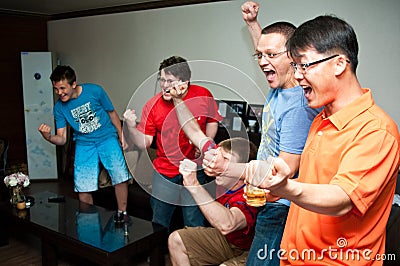 Men watching sport on TV Stock Photo