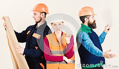Men and woman in helmets carefree with hammer and project Stock Photo