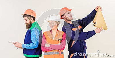 Men and woman in helmets carefree with hammer and project, Stock Photo