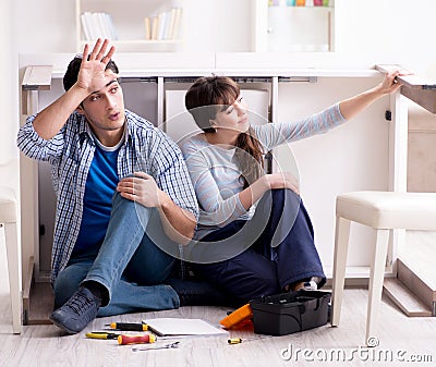 Man and woman assembling furniture at home Stock Photo