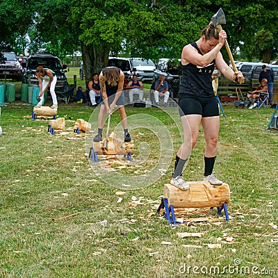 Men and women in a axe wood chopping competition, Motueka A and P show Editorial Stock Photo