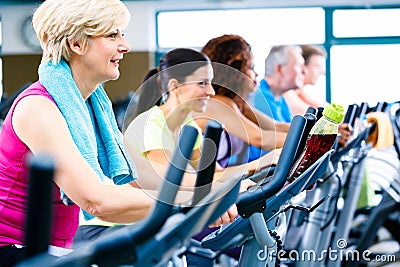 Men and women doing fitness spinning for sport Stock Photo