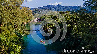 men and women in kayak in the rainforest of Thailand Stock Photo