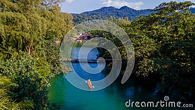 men and women in kayak in the rainforest of Thailand Stock Photo