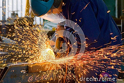 Men at work grinding steel Stock Photo