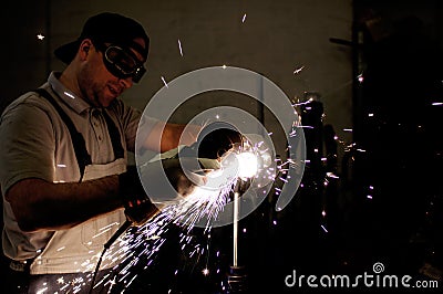 Men at work grinding steel Stock Photo