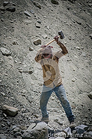 Men working at the construction road in inhuman conditions on June 14, 2018 in KHARDUNG LA PASS, Jammu and Kashmir, India. Editorial Stock Photo