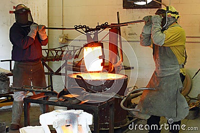 Men Working in the Foundry Hot Furnace Stock Photo