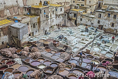Men working in a traditional Moroccan tannery. Editorial Stock Photo