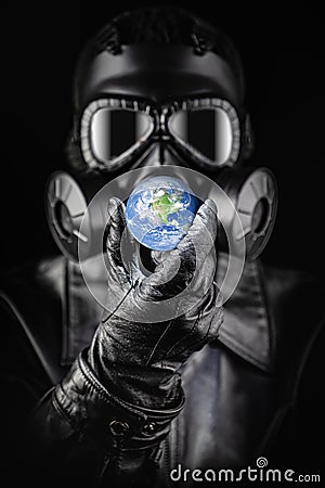 Menacing Entity Wearing Fallout Gas Mask Threatening Planet Earth With Gloved Hand Stock Photo