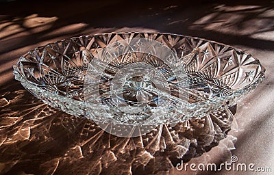 Menazhnitsa - a glass dish with four sections, standing on the table with highlights and reflections Stock Photo