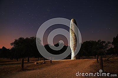 Menhir lit at night Stock Photo