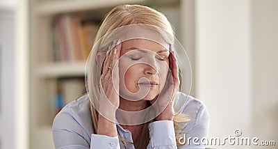 Menopausal Mature Woman At Home Suffering With Headache Pain Stock Photo
