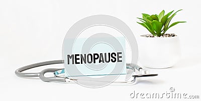 menopause word on notebook,stethoscope and green plant Stock Photo