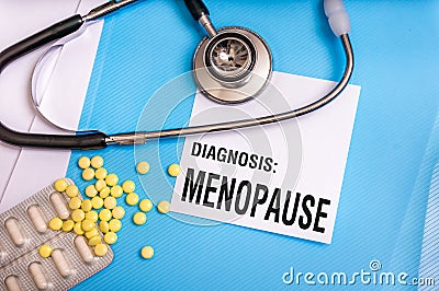 Menopause word written on medical blue folder Stock Photo