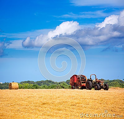 Menorca combine tractor wheat with round bales Stock Photo