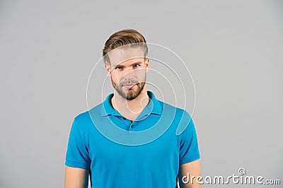 Mens beauty, fashion and style. Man in blue tshirt on grey background. Guy with bearded unshaven face. Macho with blond hair and s Stock Photo