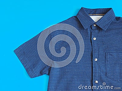 Mens short sleeved shirt. Blue shirt on a blue background Stock Photo