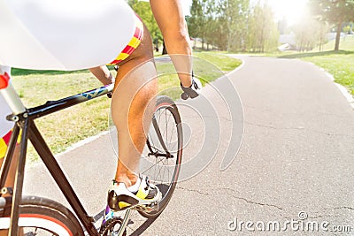 Mens sport riding a bicycle in the park at asphalt road. Stock Photo