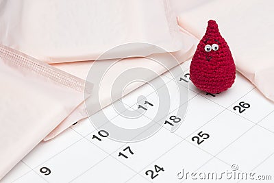 Menstrual calendar, pads and crochet blood drop. Medical conception photo. Menstrual pads for woman critical days, gynecological m Stock Photo