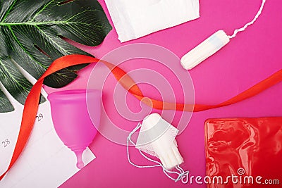 Menstrual cycle, calendar of bleeding periods during menstruation and hygiene for women, pads and tampons,cup on a pink background Stock Photo