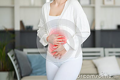 Menstrual pain, woman with stomachache suffering from pms at home, endometriosis, cystitis and other diseases of the urinary Stock Photo