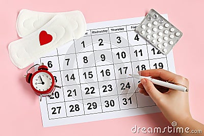 Menstruation calendar with pads, alarm clock, hormonal contraceptive pills. Female& x27;s menstrual cycle concept Stock Photo