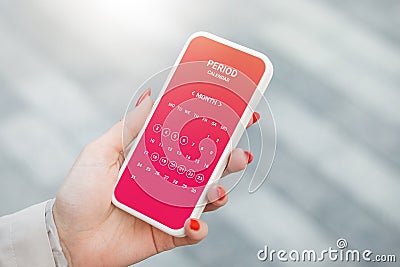 Menstruation calendar. Woman tracking periods by using menstrual calendar app on phone Stock Photo