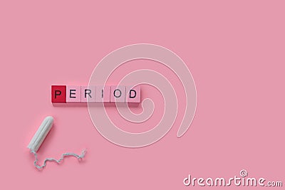 Menstruation concept: word period spelled with pink letters on pink background with a tampon Stock Photo