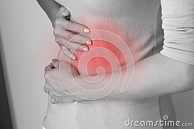 Menstruation pain or stomach ache, hand holding belly Stock Photo