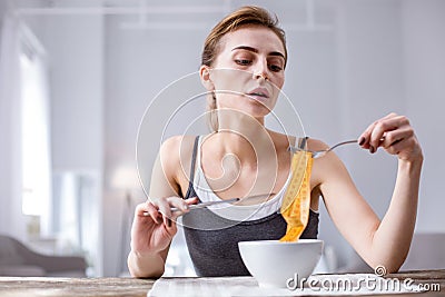 Cheerless underweight woman having a meal Stock Photo