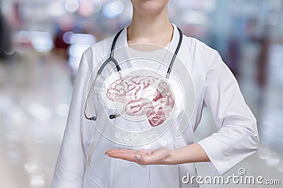 A mental health brain and cogwheel mechanism modal above a hand of psychologist Stock Photo