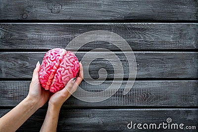 Mental health concept with brain in hands on wooden background top view space for text Stock Photo