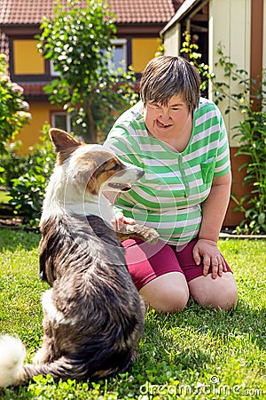 Mentally disabled woman with a second woman and a companion dog Stock Photo